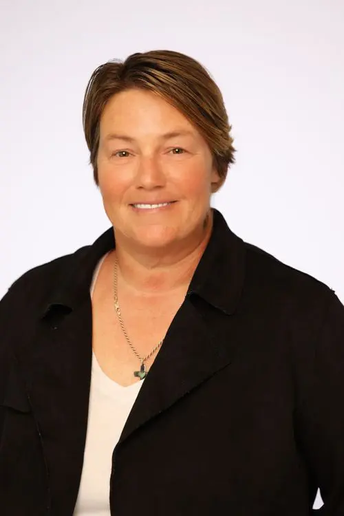 Smiling woman in professional attire.