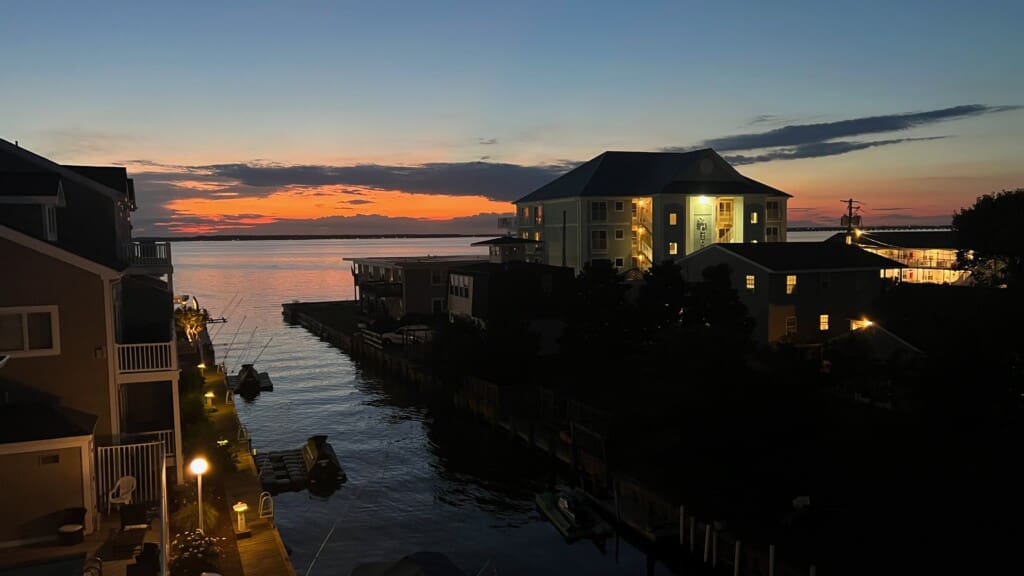 Sunset over calm water and buildings
