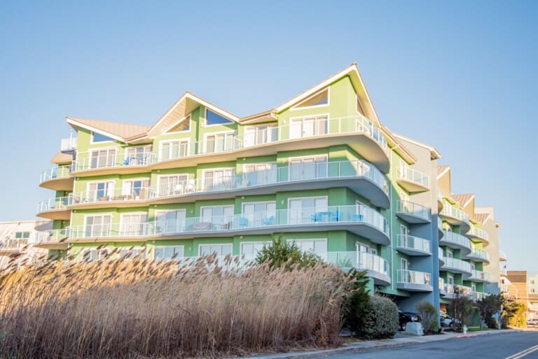 Modern green apartment building exterior near the marsh